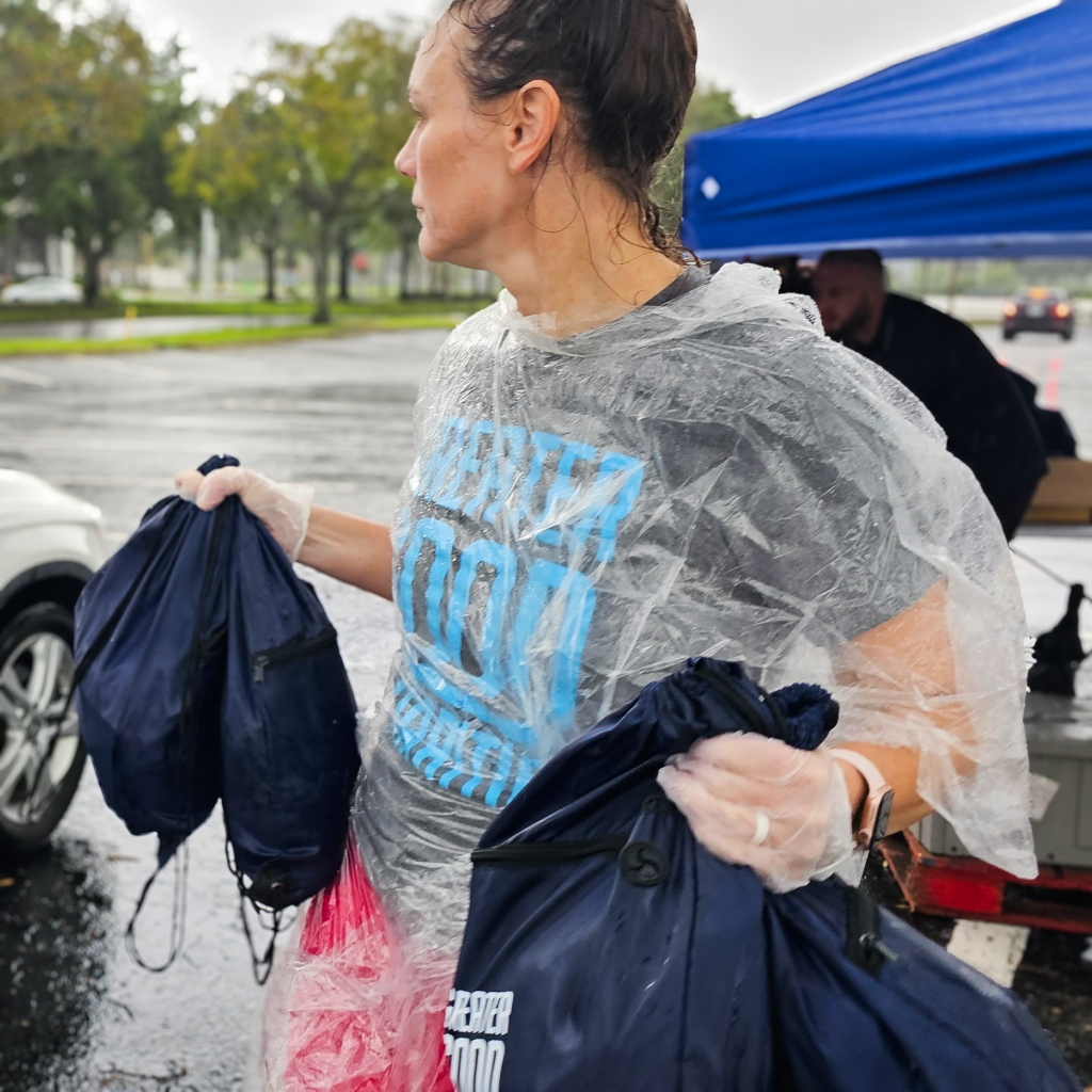 Volunteer Kristin Armer handing out Good Packs at Feeding Tampa Bay distribution. Food/water/Good Pack distribution with Feeding Tampa Bay during Hurricane Helene